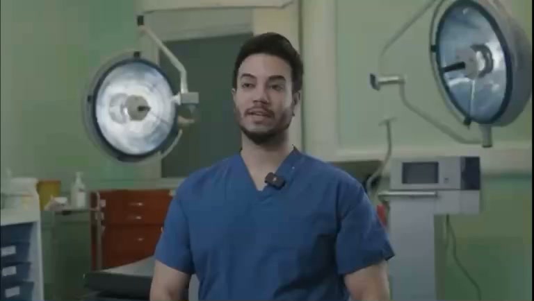 Dr Hisham Band in theatre scrubs