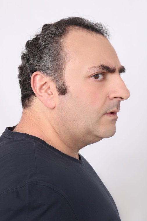 A man in profile, his temples catching the light