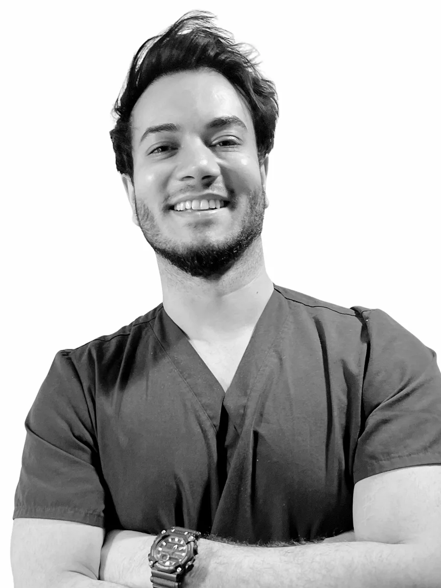 Dr Hisham Band, GMC registered doctor, photographed in navy surgical scrubs